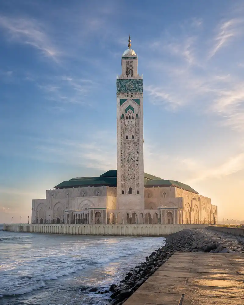 The Hassan II Mosque in Casablanca at sunrise, seen from the seafront promenade