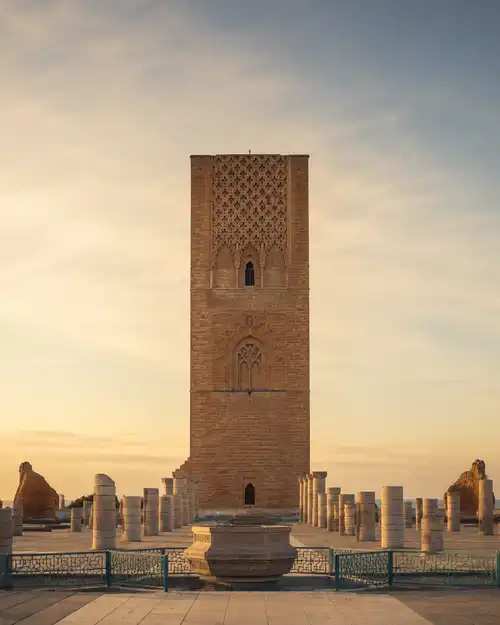The Hassan Tower in Rabat at golden hour, surrounded by the columns of the unfinished mosque